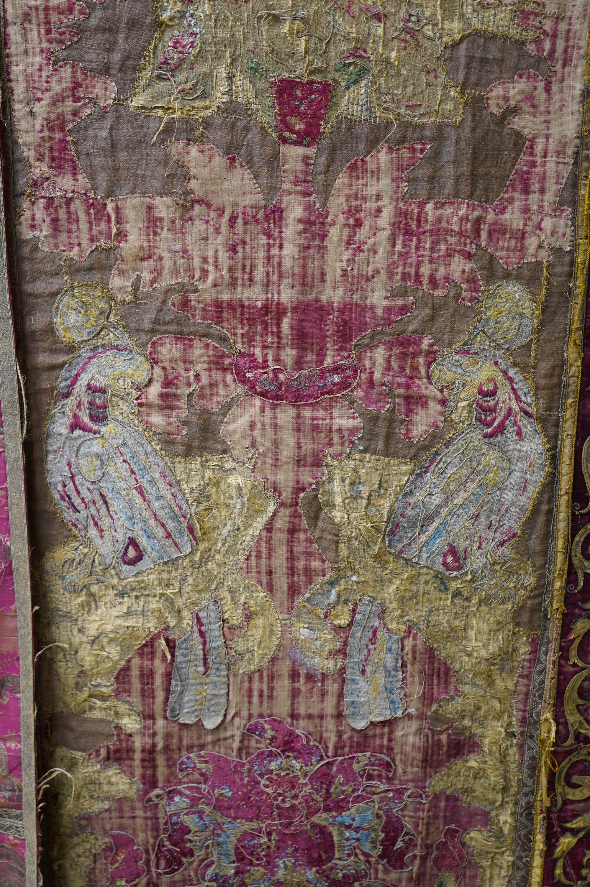 A fine Italian Renaissance style velvet, embroidered and appliqué wall hanging, originally part of a pilaster hanging, made with crimson silk velvet, gold appliqué and colourful polychrome silk embroideries of parrots an